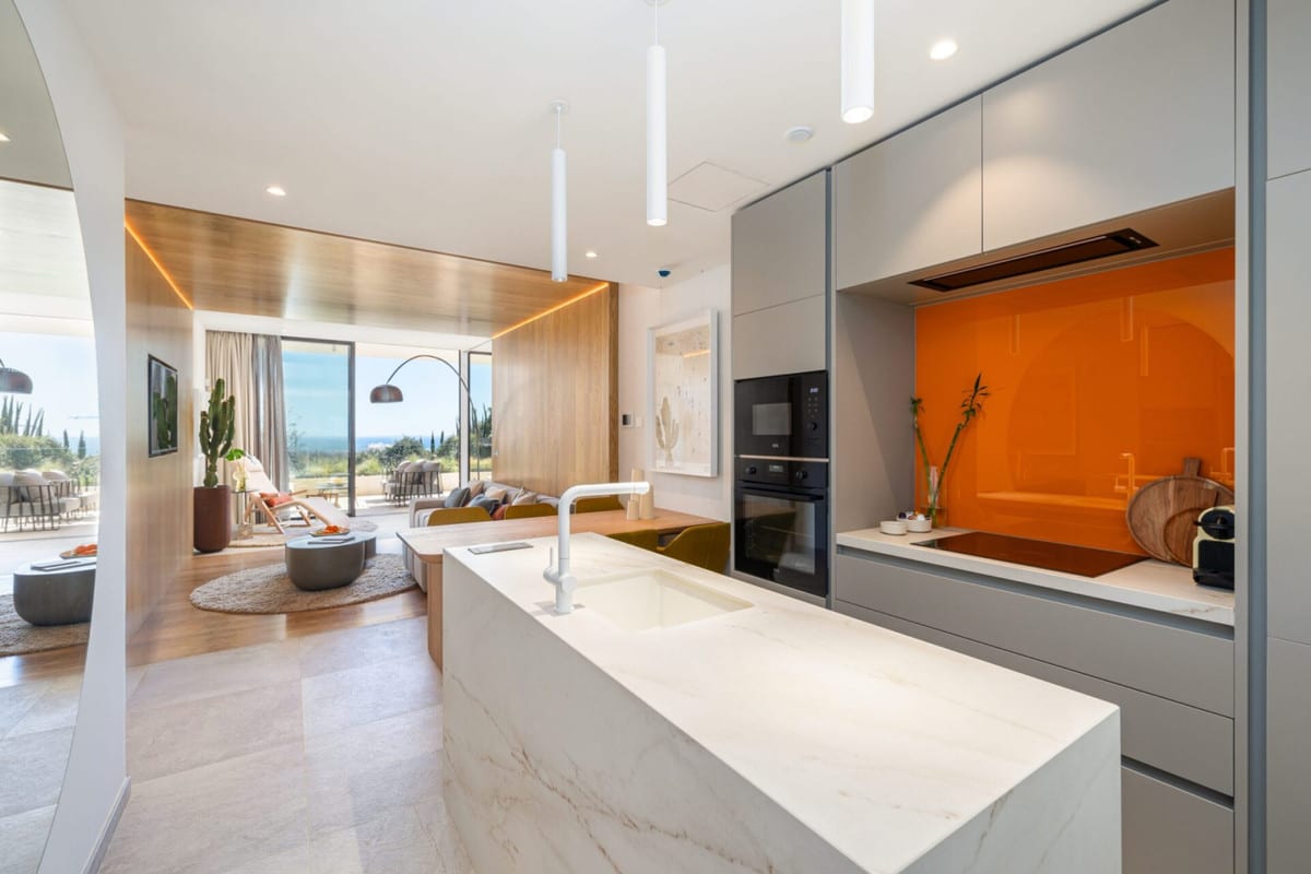 Kitchen visualisation of HIGUERON NORTH RESIDENCES with fitted cabinetry, worktop area and natural light.