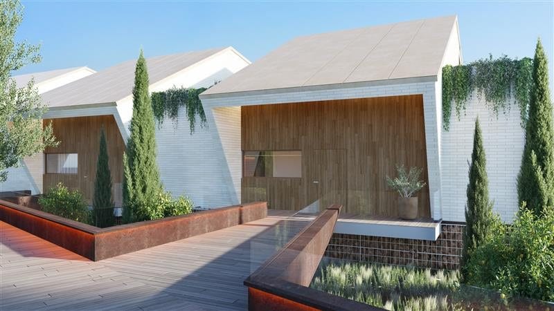 Project visualisation of the entrance to HIGUERON NORTH RESIDENCES, with white façades, wooden panels and a footbridge between raised planted beds.