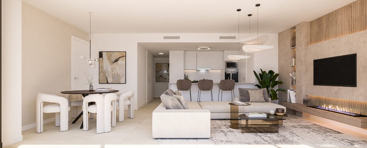 Rendered interior visualisation of IDYLLIC with an open-plan living area: round dining table with white chairs, light corner sofa, bar stools at a kitchen island, white kitchen in the background, wall-mounted television and linear fireplace with a wooden surround.
