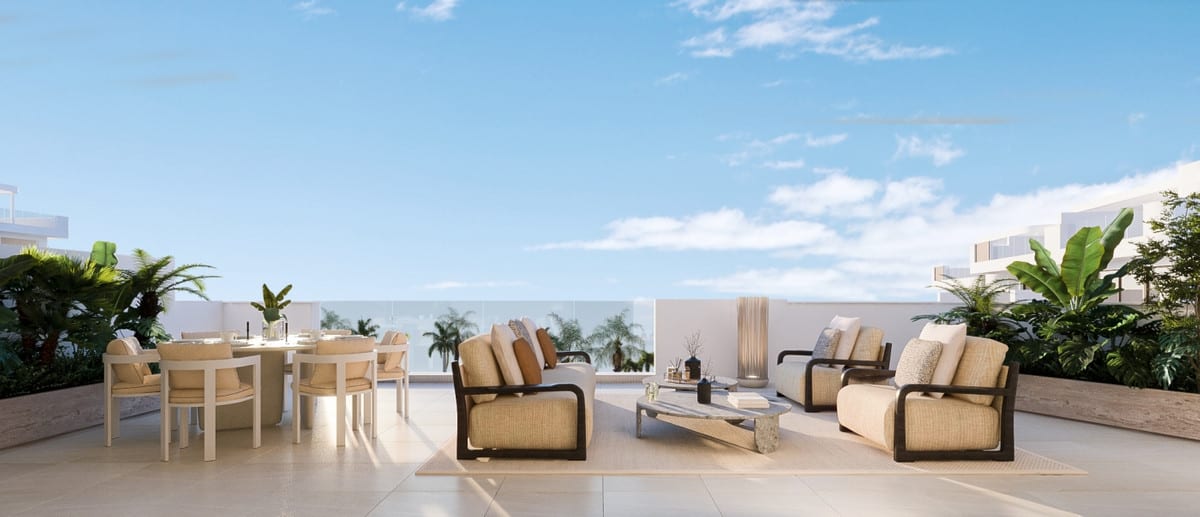 Rendered project visualisation of IDYLLIC with a terrace featuring a round dining table and chairs on the left, two lounge armchairs and a sofa with coffee table on the right, a glass balustrade in the background and tropical planting in raised planters.