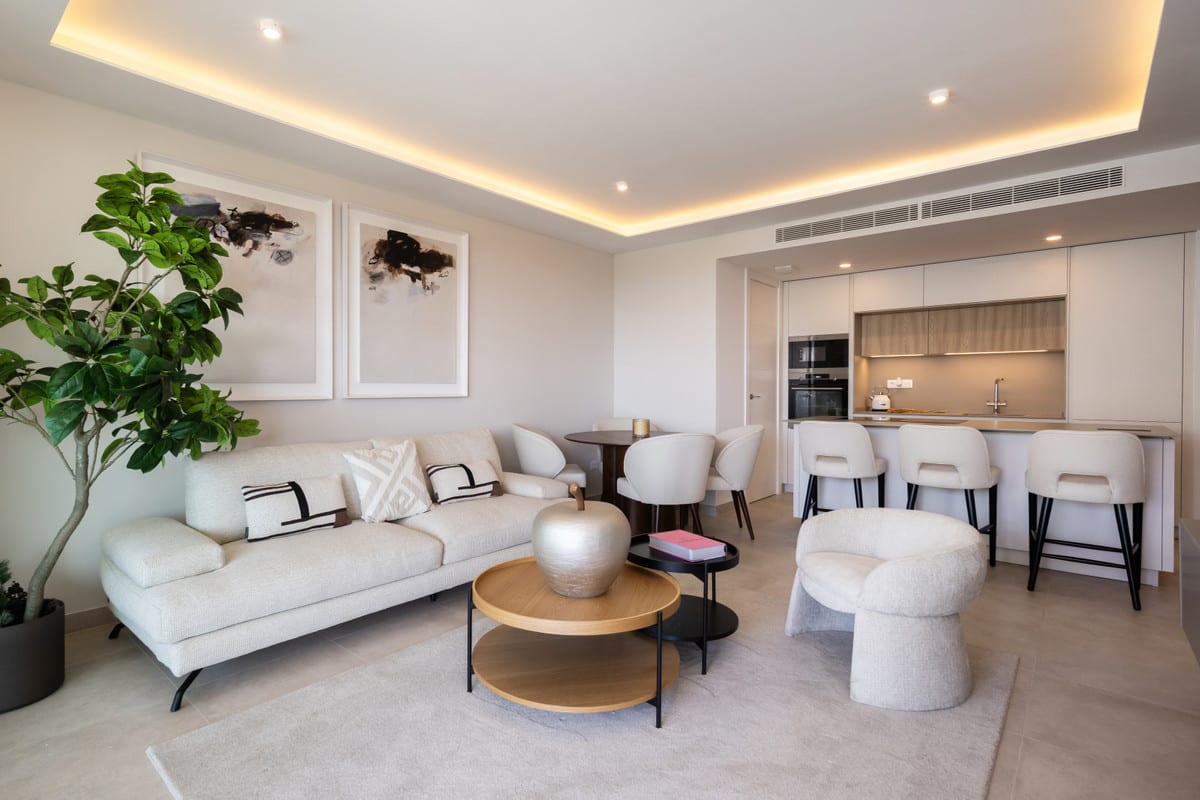 JADE TOWER WITH FURNITURE with a furnished seating area, round dining table and open-plan kitchen with bar stools.