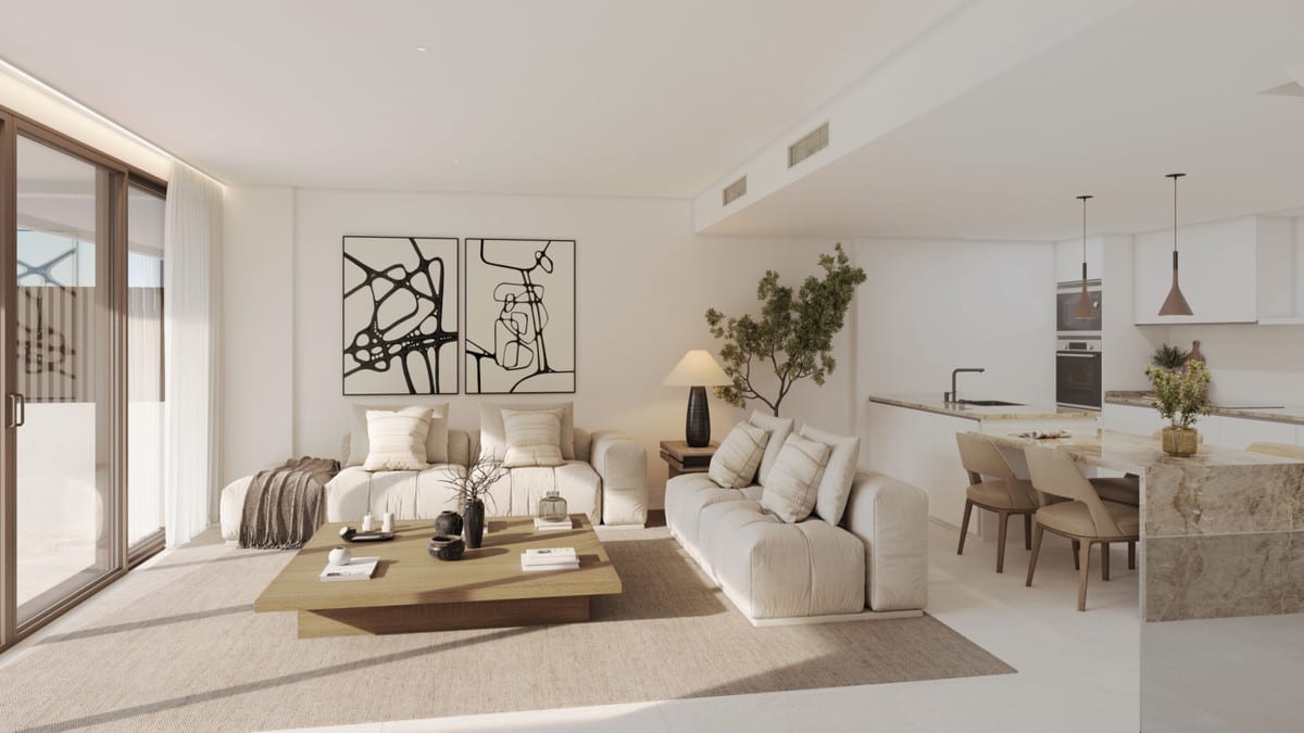 Rendered open-plan living area at KALA RESIDENCES with two light-coloured sofas, a wooden coffee table on a rug, dining area and kitchen with a marble-look island.