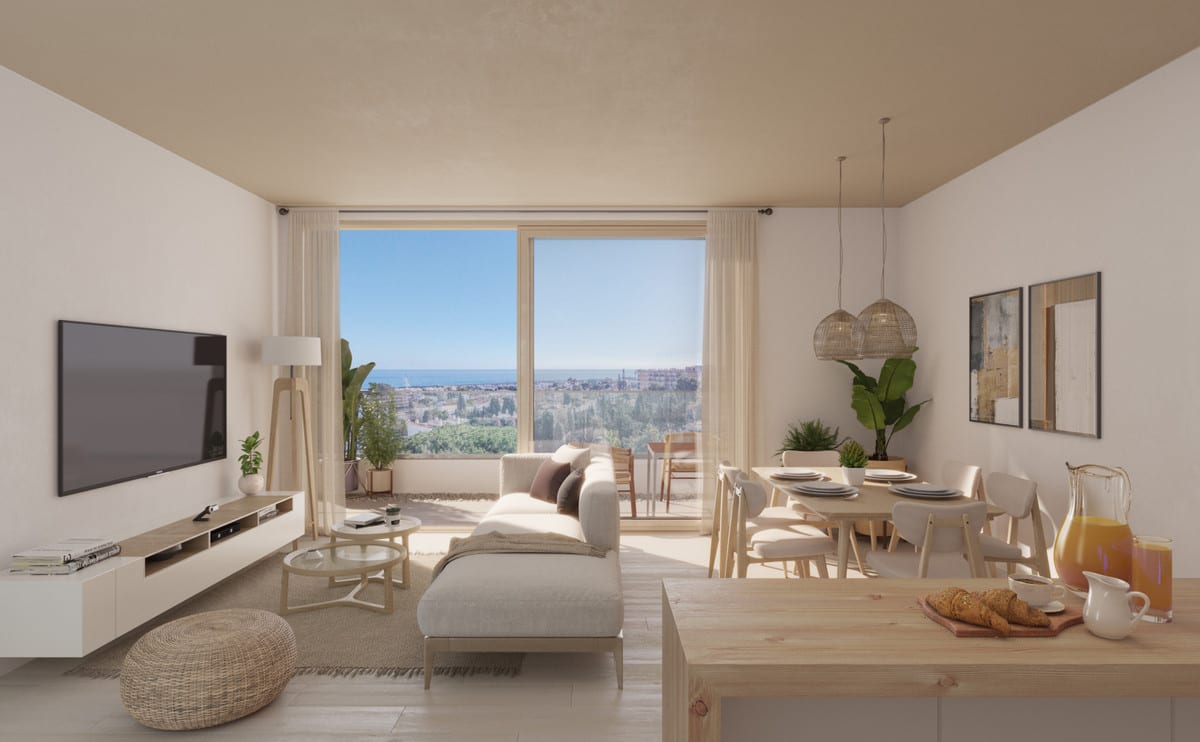Rendered interior visualisation of KOOL HOMES with a seating area, dining table, wooden kitchen island in the foreground and a large window/door opening with views of an urban landscape and the sea in the distance.