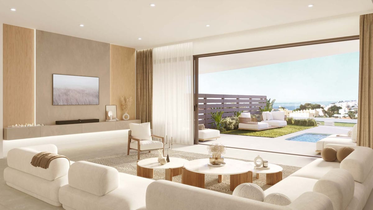 Project visualisation of KORALL with a bright living room, white sofas, wooden coffee tables, vertical wooden wall panels, a television and wide sliding doors opening onto a terrace with outdoor seating and a swimming pool visible in the background.