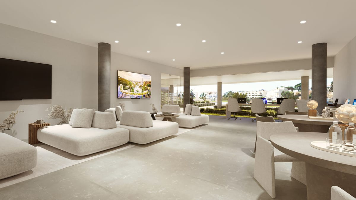 Project visualisation of KORALL with a spacious, light interior, modular white sofas, round tables, desk chairs with laptops, concrete columns and large open passageways leading to a planted outdoor area.