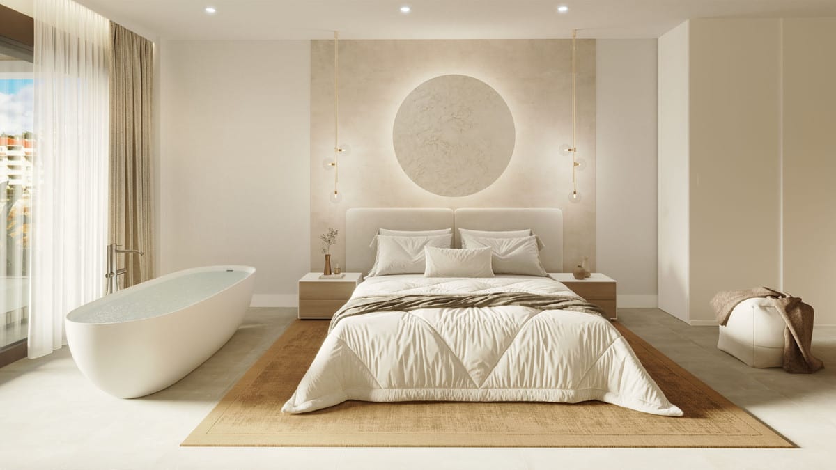 Project visualisation of KORALL with a bedroom featuring a freestanding white bath, a double bed with cream-coloured bedding, wooden bedside tables with hanging pendant lights and an illuminated round wall decoration above the headboard.