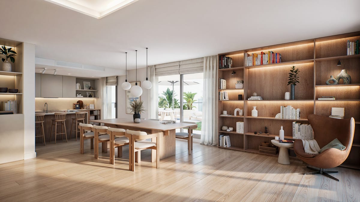 Project visualisation of LAKÜN featuring an open-plan living space with a light wooden floor, wooden dining table with hanging globe lights, a kitchen with bar stools in the background, an illuminated built-in bookcase and sliding glass doors to the outside.