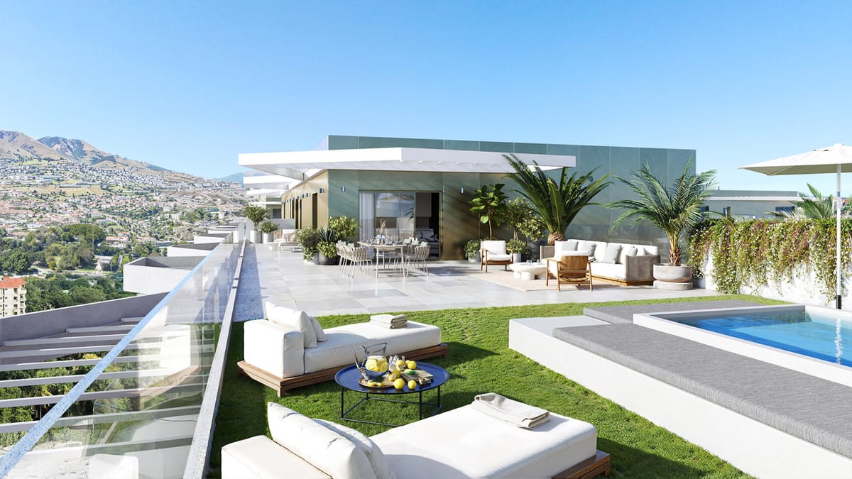 Project visualisation of LAKÜN featuring a spacious roof terrace with lawn areas, white lounge furniture, a dining table, palm trees, a private swimming pool, glass balustrade and a backdrop of hills with buildings.
