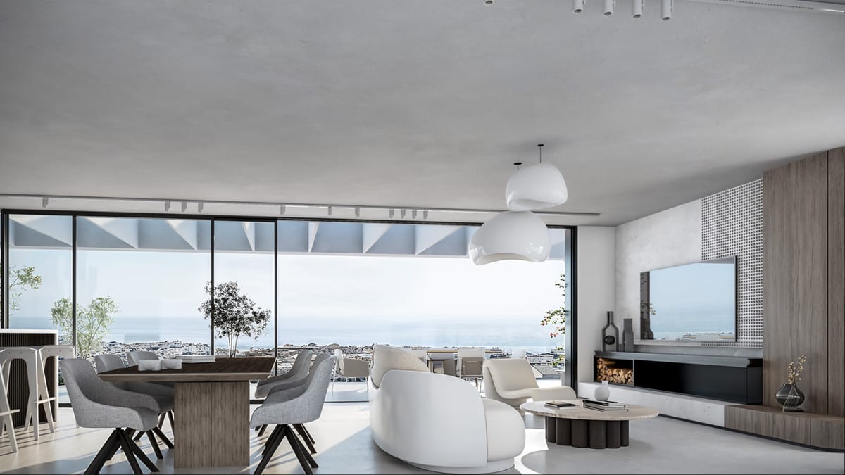 Project visualisation of LAS MESAS BLUE HORIZON featuring a living and dining area, white curved sofa, round coffee table, TV wall unit with fireplace and wide floor-to-ceiling glazed doors, with a rendered coastal panorama in the background.