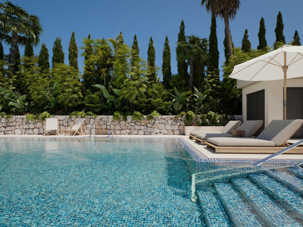 Project visualisation of LAS MESAS SEA SUITE with a blue-tiled swimming pool with steps, wooden-framed sun loungers, a parasol and lush planting behind a natural stone wall.
