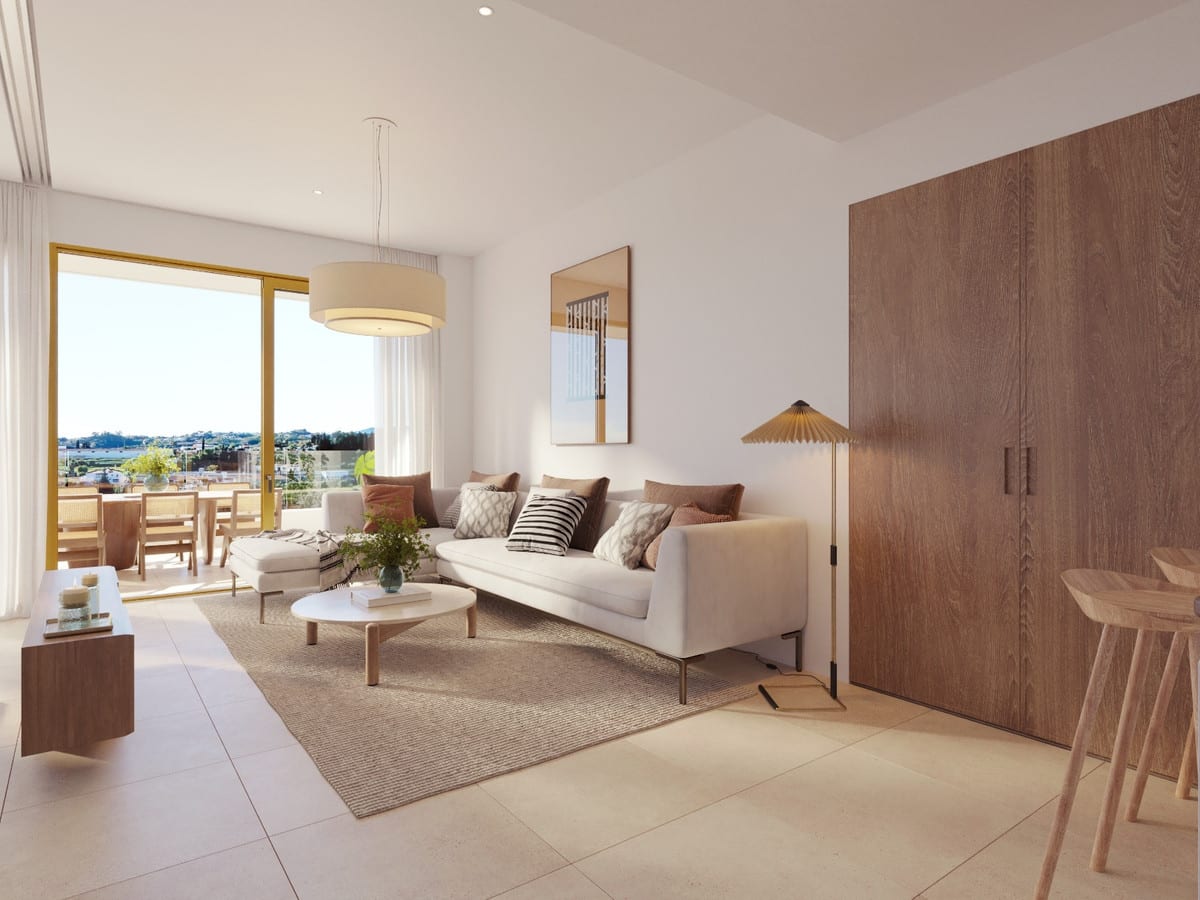 Project visualisation of LUMINAL HOMES featuring a living room with a white sofa, round coffee table, rug, large wooden cabinet and sliding glass doors leading to a terrace with a dining table.