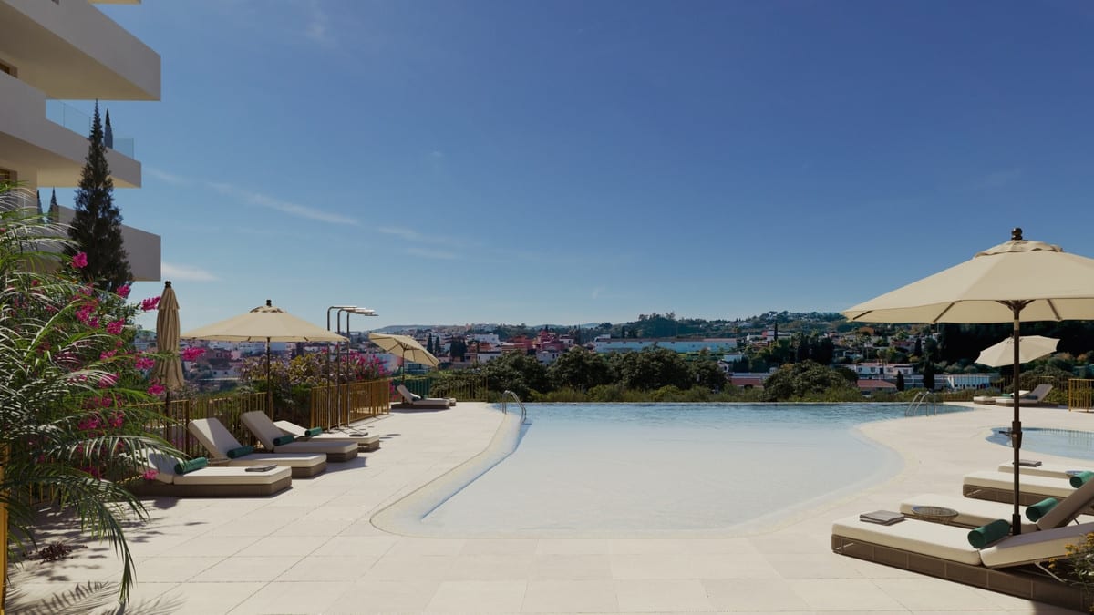 Project visualisation of LUMINAL HOMES featuring an infinity pool, sun loungers, parasols, flowering planting and views of surrounding buildings and greenery in the background.