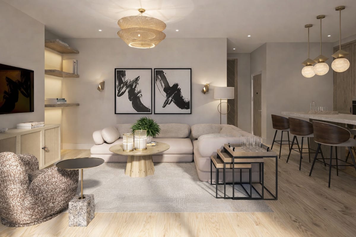 Project visualisation of LUNA NOVA RESIDENCES featuring a living room with a light corner sofa, woven armchair, rug, two black-and-white wall paintings and an open kitchen with bar stools on the right.