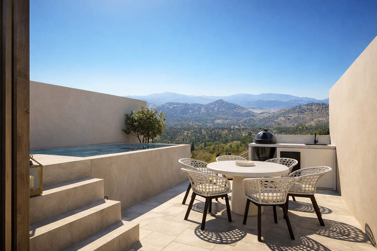 Project visualisation of the terrace at LUNA NOVA RESIDENCES with a small rectangular pool, round dining table, four chairs, barbecue and mountain landscape in the background.
