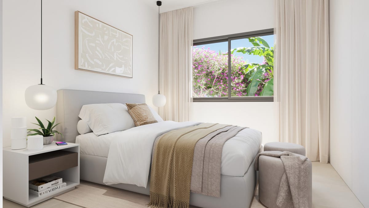 Project visualisation of MALA KAI featuring a bright bedroom, an upholstered double bed with beige bedding, two round pendant lights, a white bedside table, an upholstered bench at the foot of the bed and a window overlooking pink flowering planting.