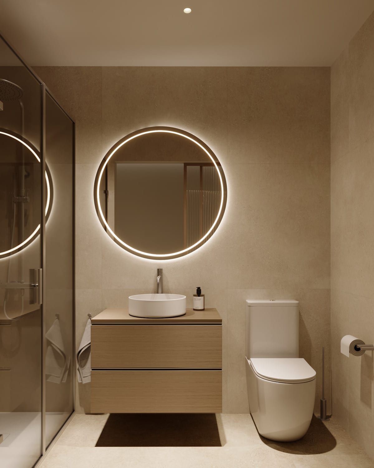 Project visualisation of MARTAGINA HILLS featuring a bathroom with textured sand-coloured walls, a light floor, a glass shower screen on the left, a floating wooden vanity unit with a countertop basin, a round illuminated mirror and a toilet.