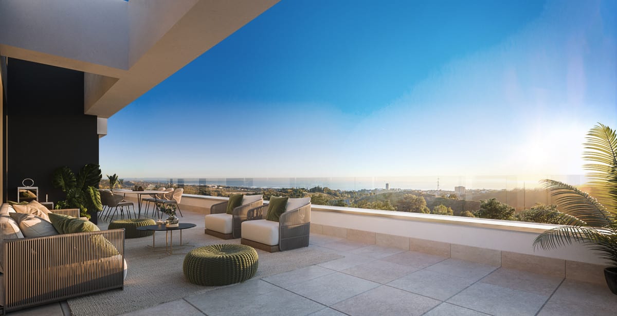 Project visualisation of MEDBLUE I, II & III with a partially covered terrace, lounge seating, dining area, glass balustrade and the sea on the horizon.
