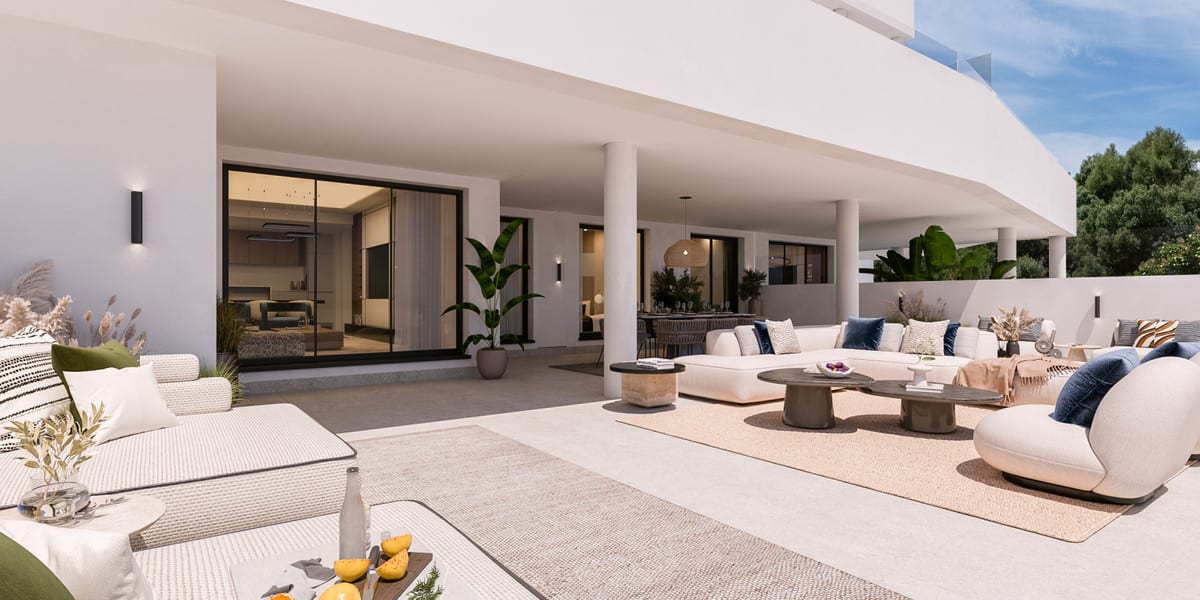 Project visualisation of MEDBLUE IV with a spacious covered outdoor area, white seating and large sliding glass doors leading to the interior.