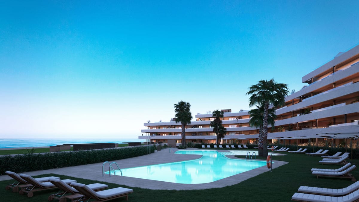 Twilight visualisation of MORASOL - BUILDING 2 with an illuminated outdoor pool, sun loungers, palm trees and water visible on the horizon.