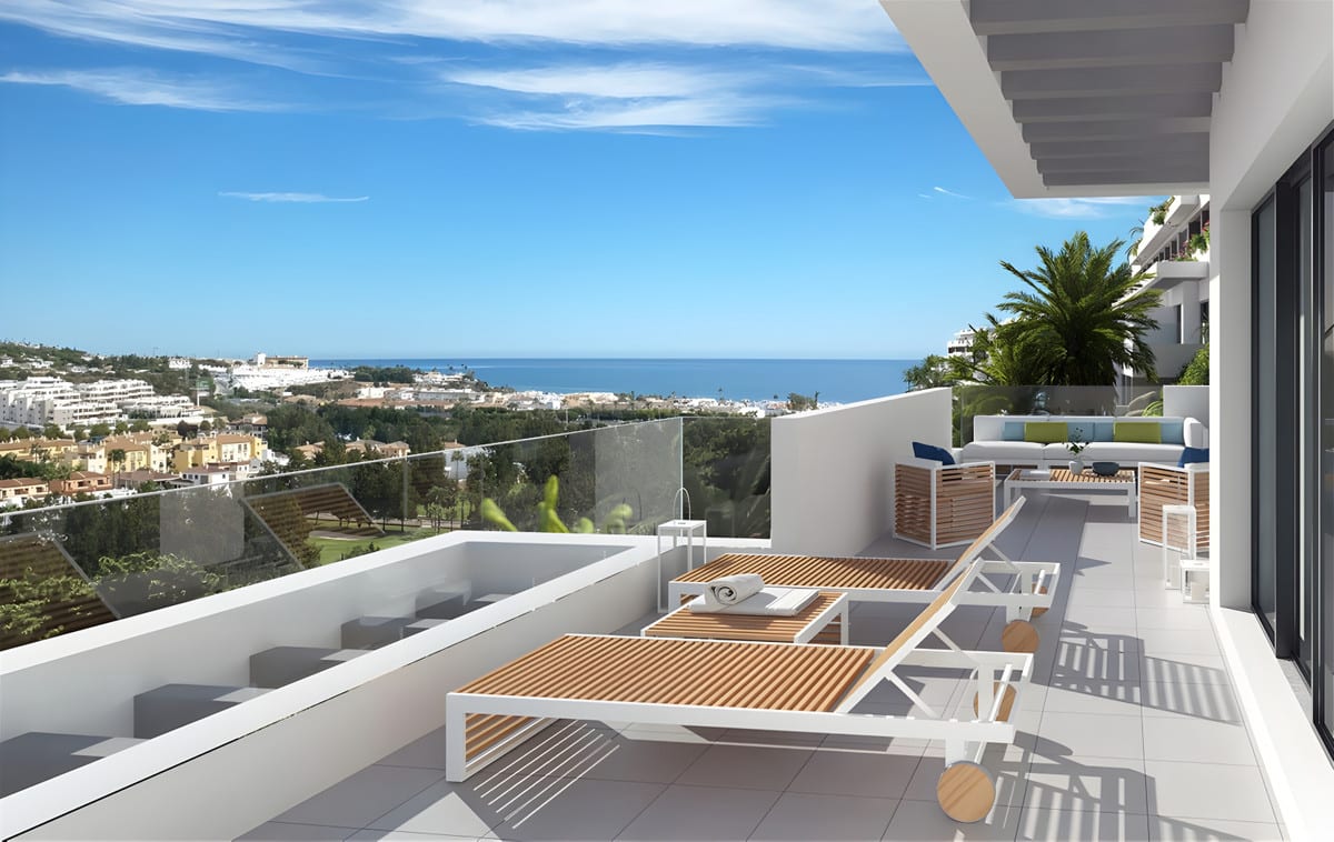 Project visualisation of a terrace at NAVIGOLF SUITES 2 with two wooden sun loungers, a glass balustrade panel, a lounge area and open views over the buildings and the sea.