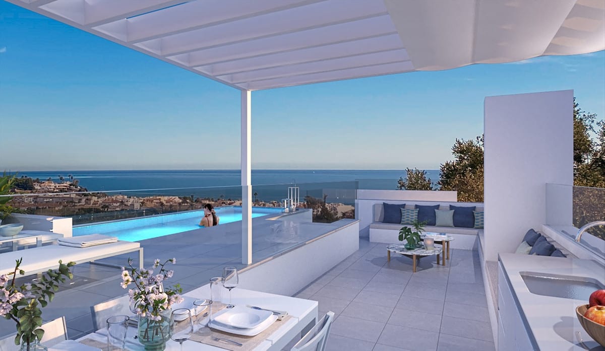 Project visualisation of NAVIGOLF SUITES 2 with a covered terrace beneath a white pergola, a laid dining table, a worktop with sink, a built-in bench with cushions, a swimming pool and the sea in the background.
