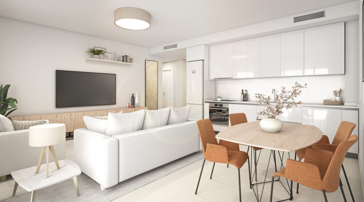 Project visualisation of NEXUS RESIDENCES with an open-plan living area: white high-gloss kitchen cabinets, an oval wooden dining table with terracotta-coloured chairs, a white sofa and a television.