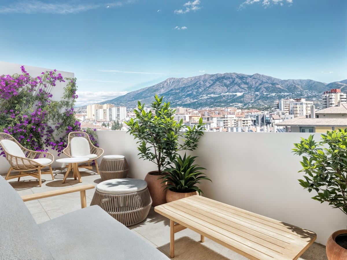 Project visualisation of NOVA MARINA showing a furnished terrace with rattan chairs, a wooden bench, potted plants, purple flowers and a city and mountain panorama in the background.