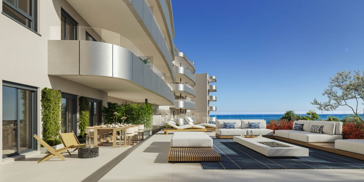 Project visualisation of the spacious terrace at ONE OAK with a lounge area, dining table, sun loungers and sea views.