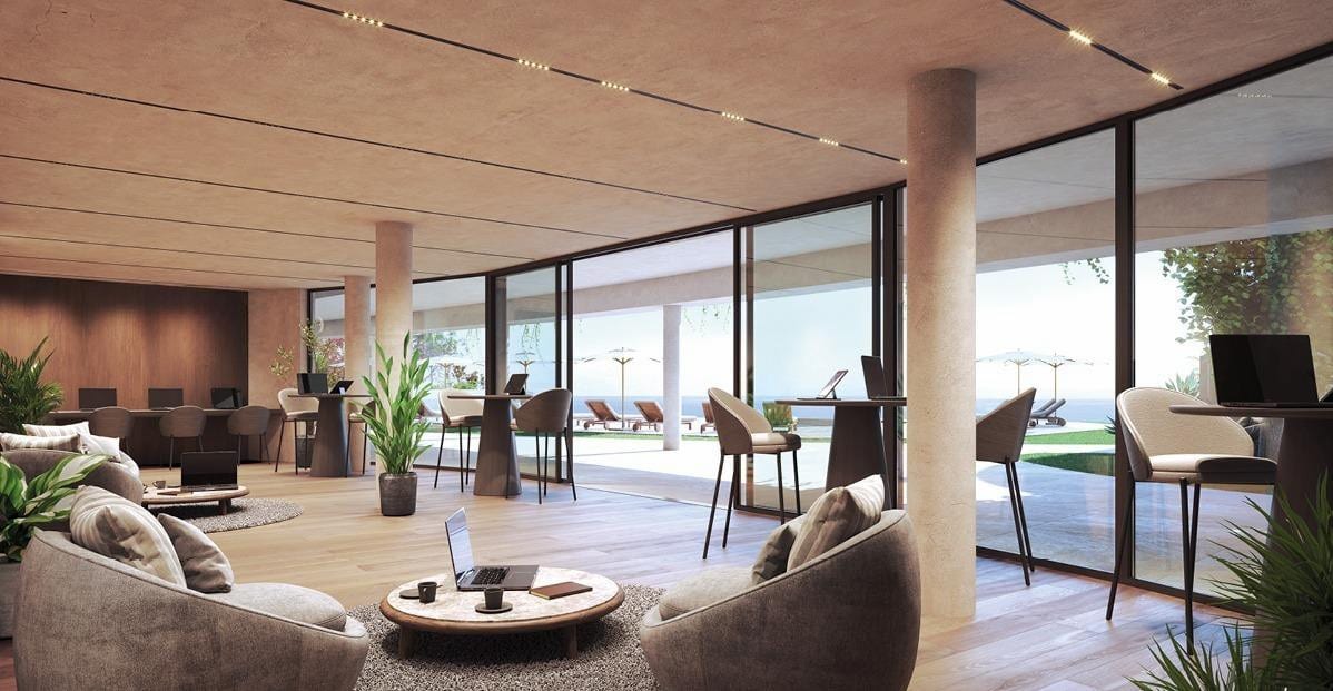 Interior visualisation of ORGANIC HIGUERÓN with a spacious communal lounge, rounded armchairs, high work tables with chairs and laptops, plants and floor-to-ceiling glass walls opening onto an outdoor area with sun loungers and parasols.