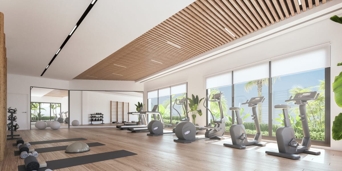 Project visualisation of ORIGIN featuring a fitness room with a wooden slatted ceiling, treadmills, cross trainers, an exercise bike, dumbbells, exercise mats, a mirrored wall and large windows overlooking planting.