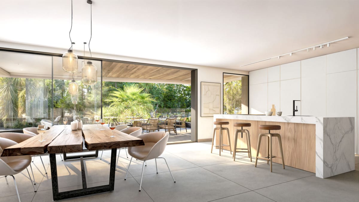 Rendered interior visualisation of PALM RESIDENCES with a live-edge wooden dining table, pendant glass lights, an open-plan kitchen with a marble-effect island and wooden bar stools, and wide sliding glass doors opening onto a covered terrace with an outdoor dining area.