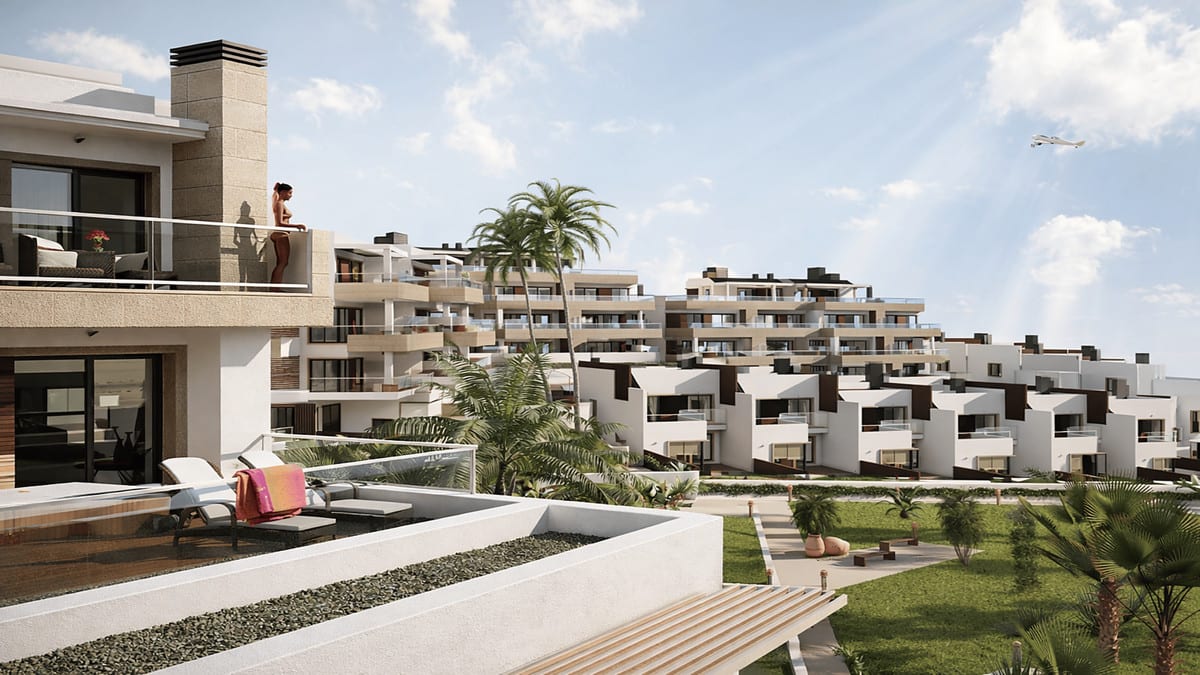 Development visualisation of PARAISO BEACH with white and sand-coloured buildings, terraces with sun loungers, glass balustrades, palm trees and a communal garden with paths and benches.