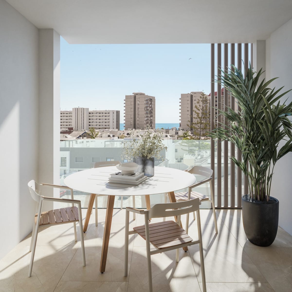 Project visualisation of PELIT MARITIMO with a covered terrace featuring a round white dining table, four chairs with wooden seats, vertical wooden slats, a glass balustrade and views across surrounding buildings towards the sea.