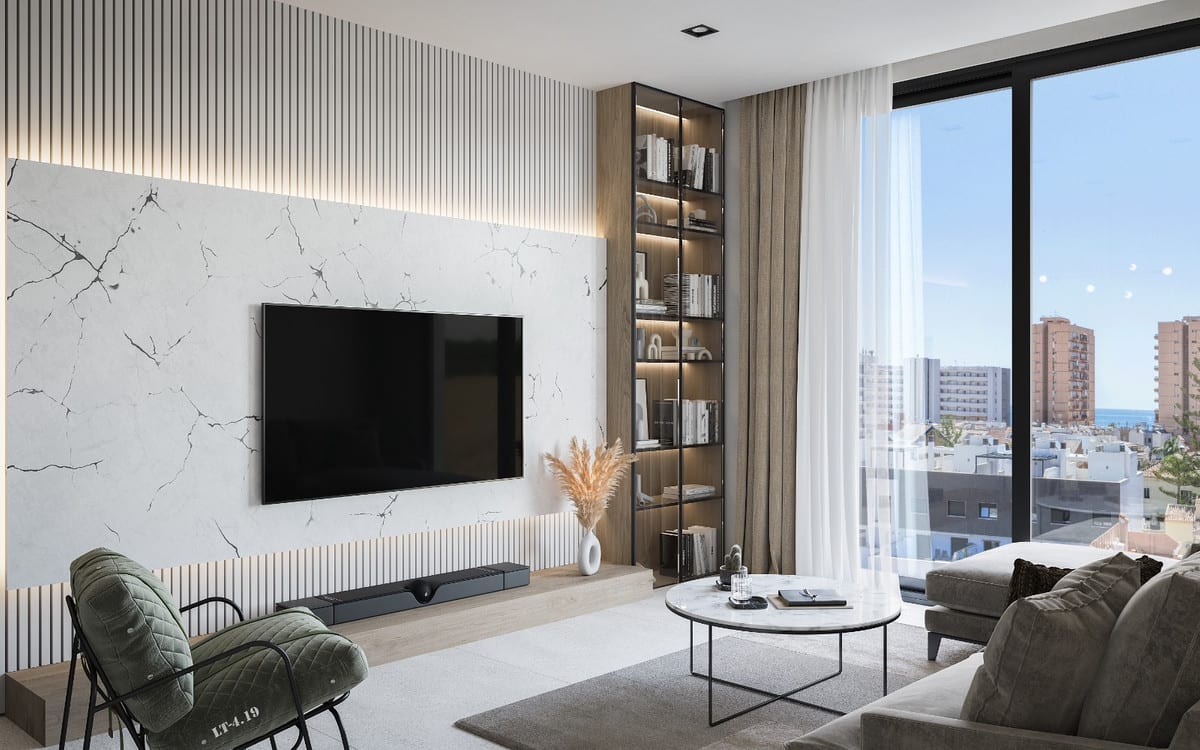 Project visualisation of PELIT MARITIMO with a living room featuring a white marble-effect wall panel with dark veining, a wall-mounted television, an illuminated open bookcase, green armchair, grey sofa, round coffee table and large window.