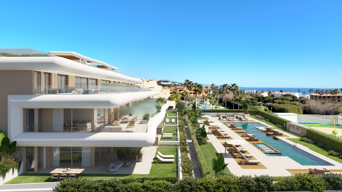 Project visualisation of PRIVILEGE SUITES with white buildings featuring rounded façades, glass balustrades, a long swimming pool, sun loungers, palm trees and the sea in the background.