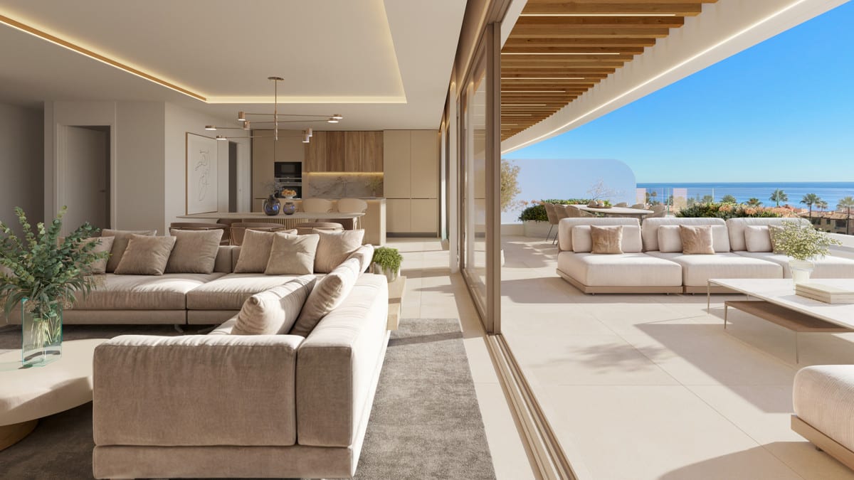 Project visualisation of PRIVILEGE SUITES with a beige corner sofa, dining area, open-plan kitchen with wooden cabinets, and a terrace with a glass balustrade and the sea in the background.