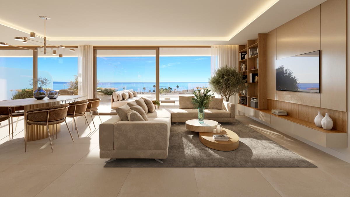 Project visualisation of PRIVILEGE SUITES with a living room, beige sofas, round coffee tables, a dining area with an oval table, a wooden media wall with television and sliding glass doors leading to a terrace with sea views.