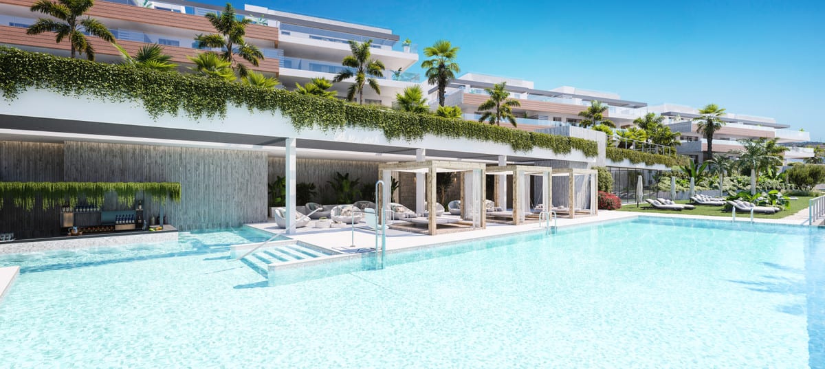 Project visualisation of QUINTESSENCE with turquoise pool water, timber cabanas, sun loungers, palm trees and white buildings in the background.