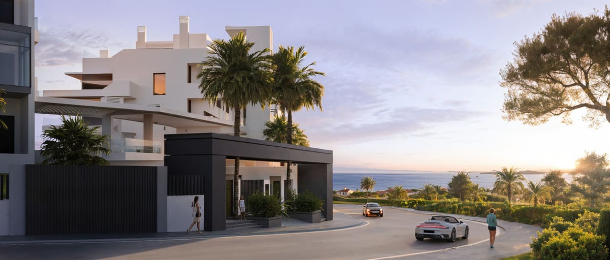 Rendered street view of RAYOS DEL SOL at dusk, with a dark covered entrance canopy, white façades, palm trees, two cars and the sea in the background.