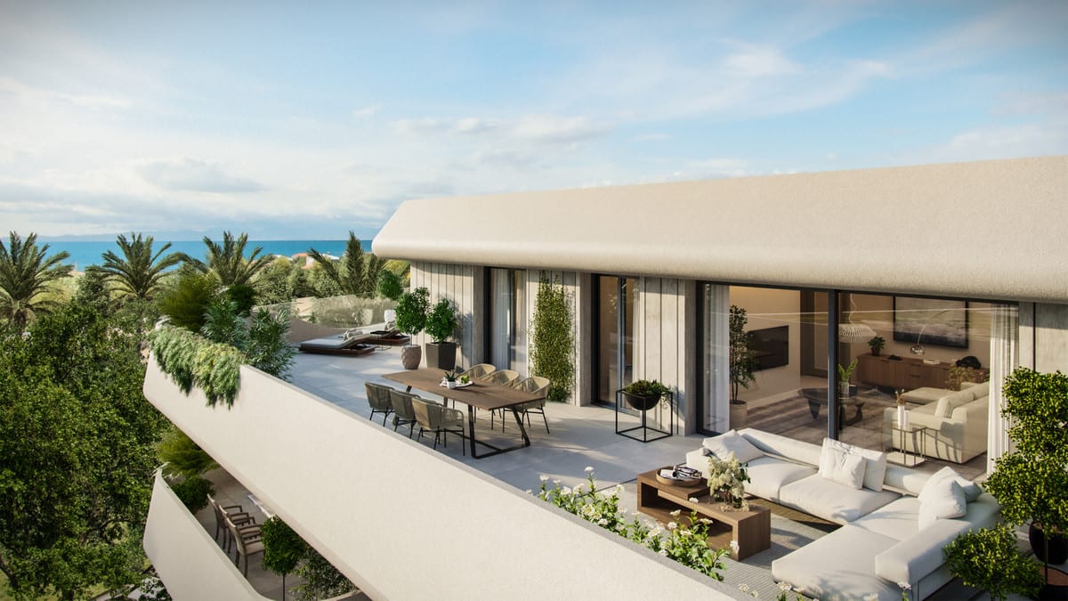 Project visualisation of SALVIA II with a spacious terrace featuring a dining table and chairs, a white lounge sofa with coffee table, planters with greenery and large glass sliding doors opening onto the living area; the sea is visible in the background of the render.