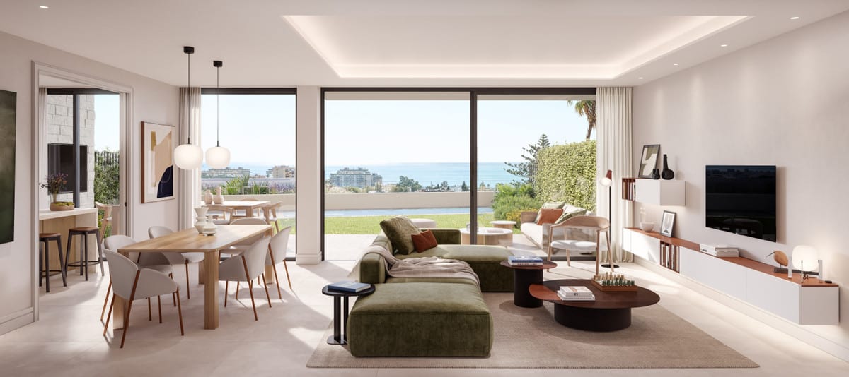 A bright living space where the seating area, dining room, and outdoor space visually merge.