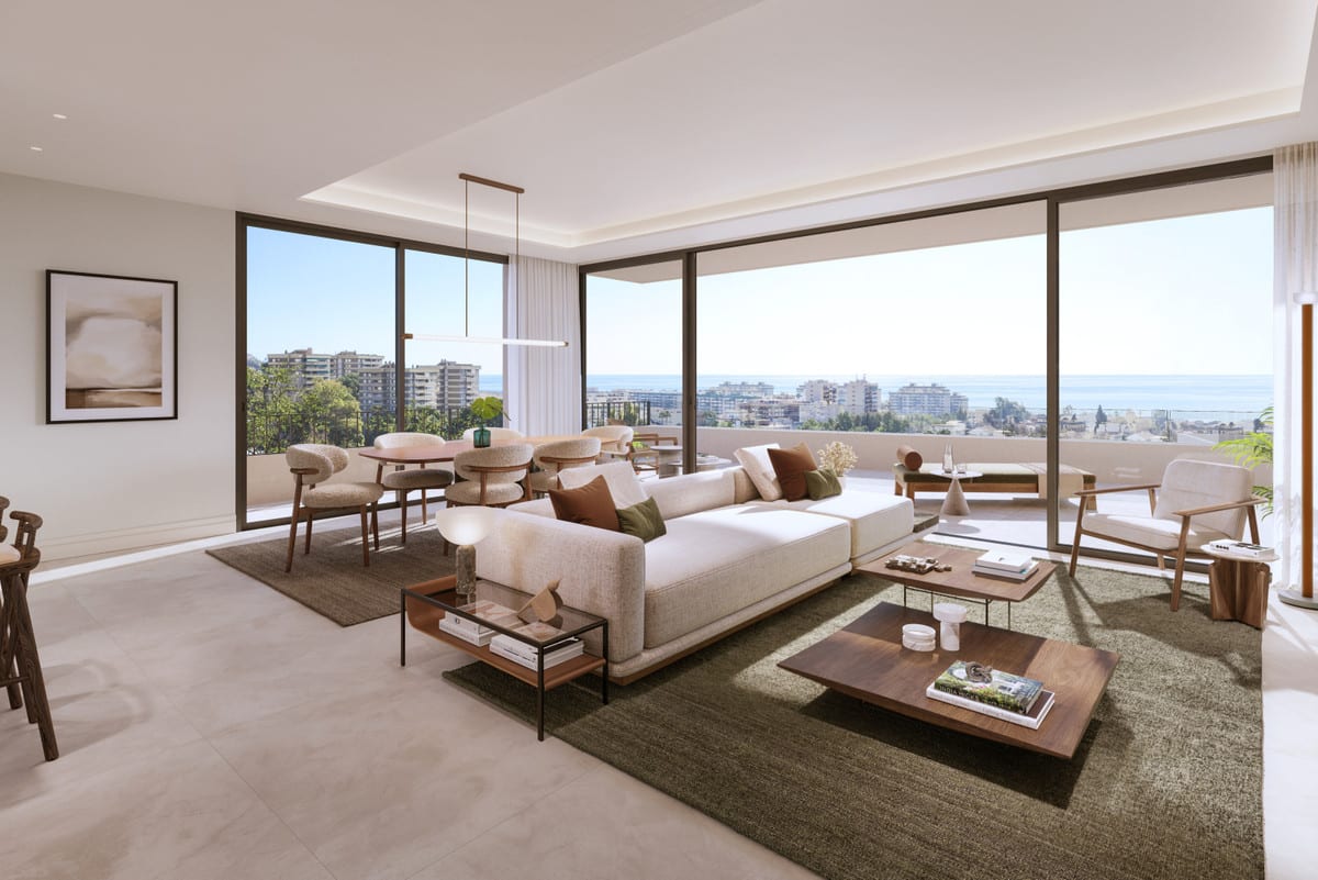 The living room is furnished with a generous seating area and opens to the terrace via glass sliding doors.