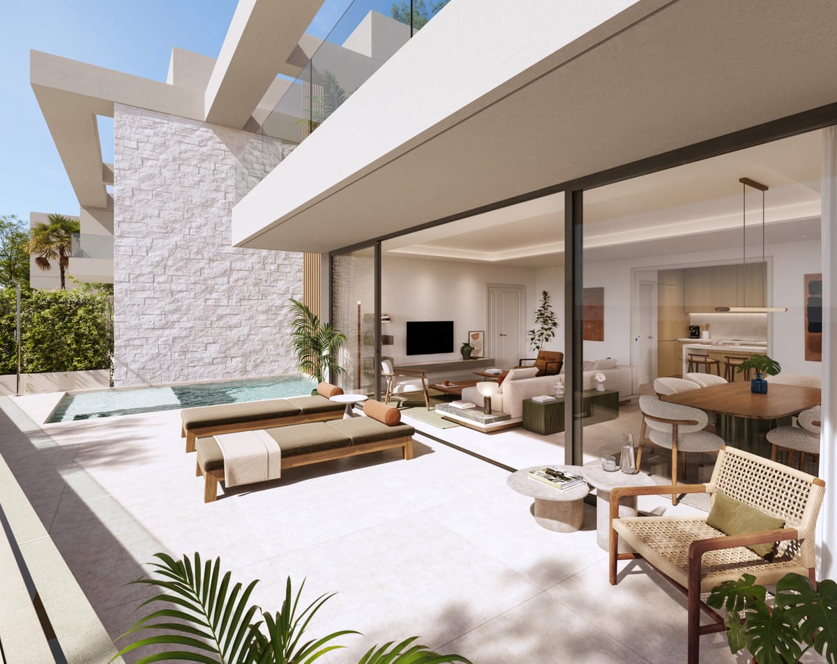 A sheltered terrace with sunbeds and a pool, directly adjacent to the living room and dining area.
