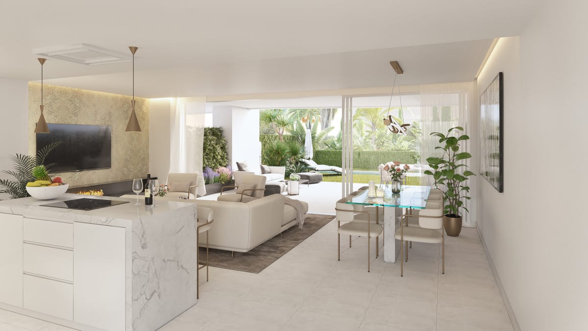 Development visualisation of SERENITY FRONTLINE GOLF HOMES AND BEACH CLUB showing an open-plan living area with a marble-look kitchen island, glass dining table, seating area, TV wall with decorative panel and sliding doors leading to a planted terrace.