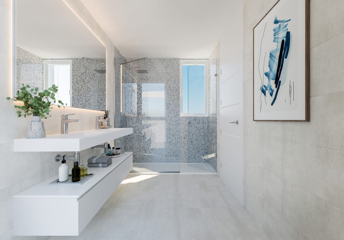 Development visualisation of SERENITY FRONTLINE GOLF HOMES AND BEACH CLUB showing a bathroom with a floating white double vanity, illuminated mirror, glass shower screen and grey mosaic tiling.