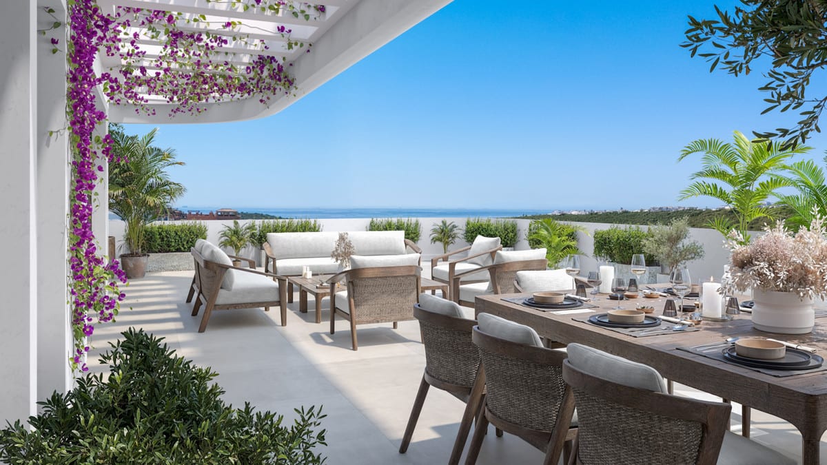 Project visualisation of the terrace at SKYE CASARES GOLF with a wooden dining table, seating area, pergola with purple flowers and the sea in the distance.