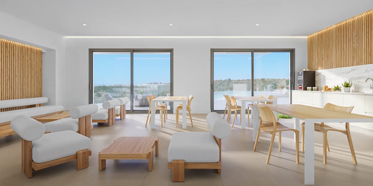 Project visualisation of a bright communal interior at SKYE CASARES GOLF with wooden wall panelling, chairs, tables and a kitchen wall.