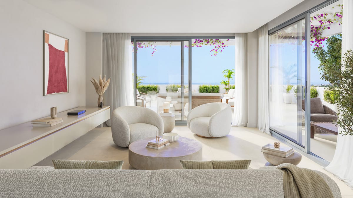Project visualisation of the living room at SKYE CASARES GOLF with rounded armchairs, a sofa, sliding glass doors and a planted terrace.