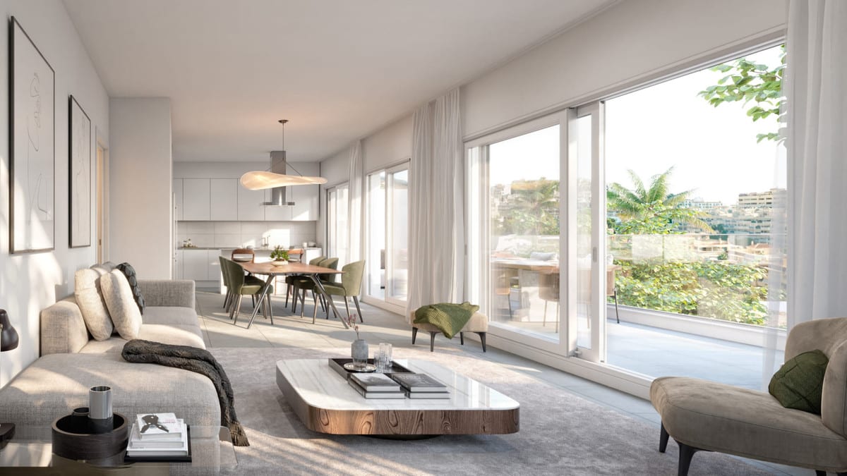Project visualisation of STELLA 8 with a bright living and dining area, open-plan kitchen, large sliding glass doors and greenery visible outside.