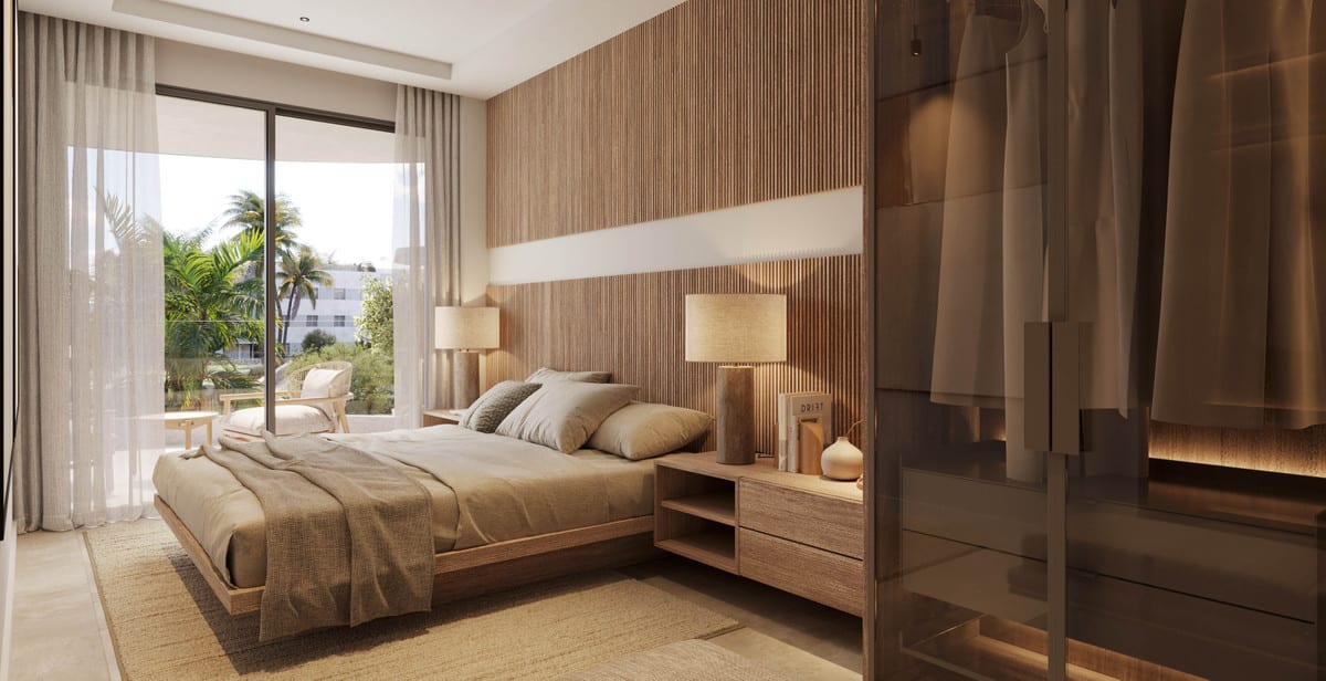 Project visualisation of THE PALMS AT ESTEPONA featuring a bedroom with a double bed, wooden slatted wall panel, open bedside tables with lamps and a sliding door to an outdoor area with palm trees.